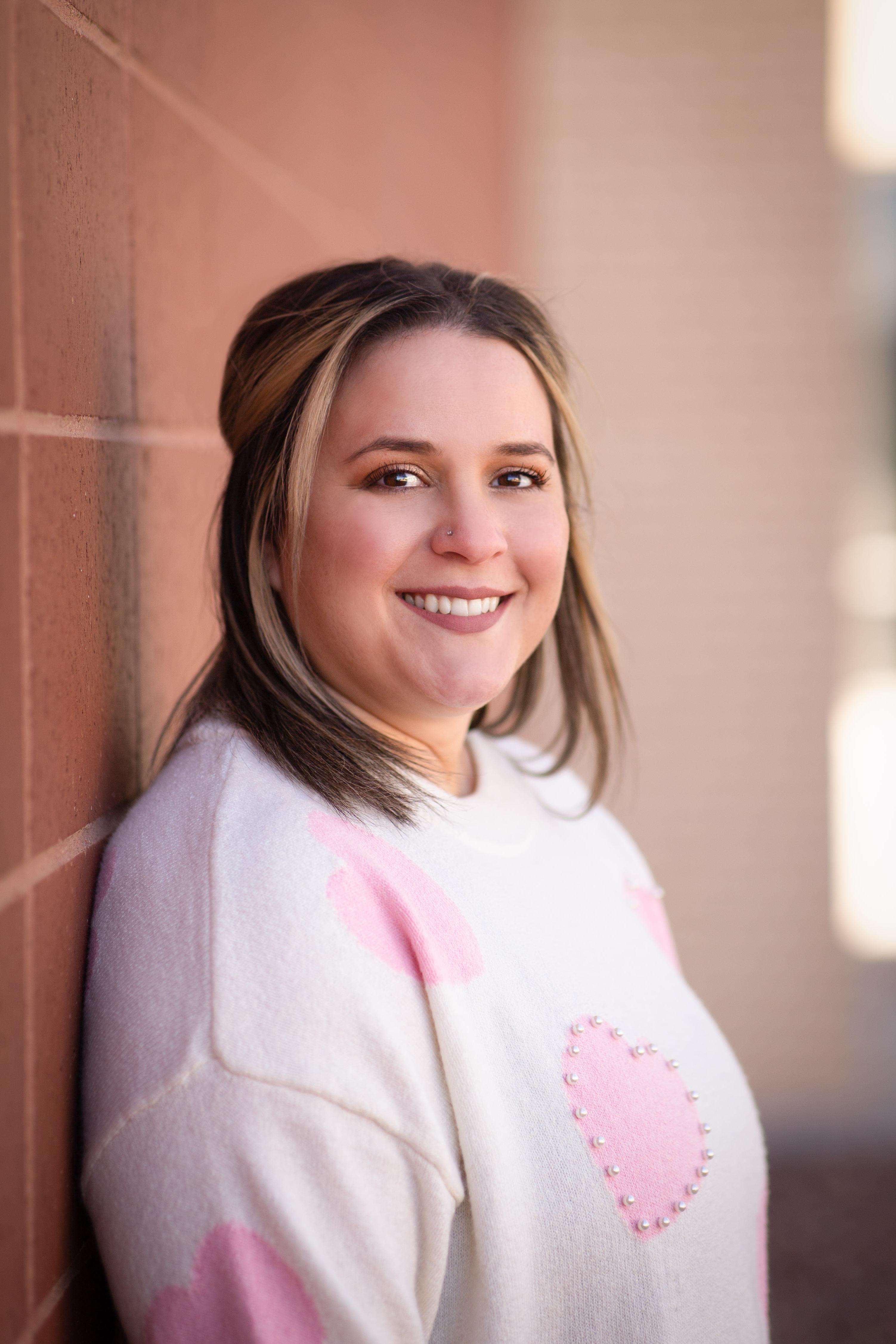  Woman in white sweater with pink hearts